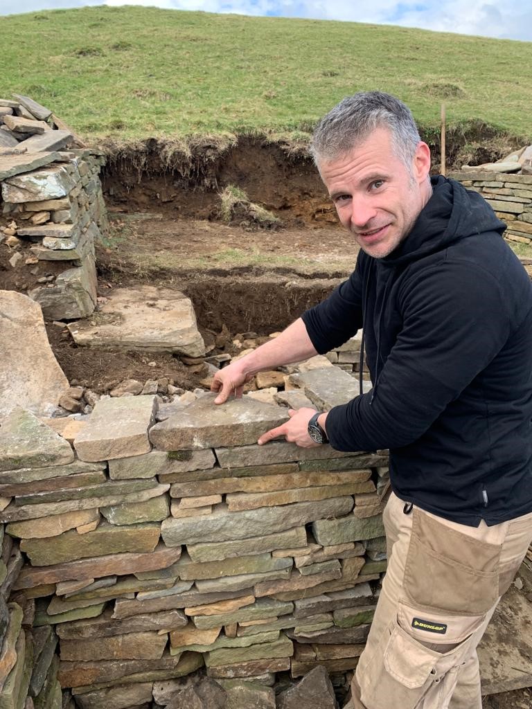 Paul Spiteri placing stones on a wall