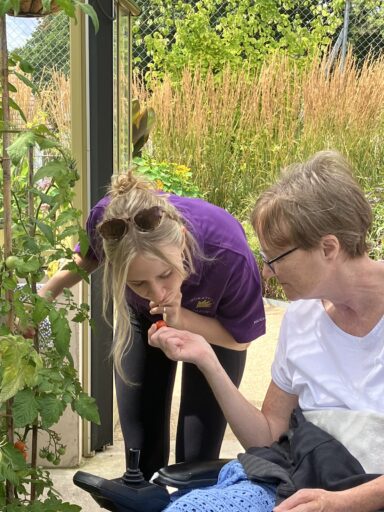 Paralegal Madeline Lloyd in the Serious Injury Team chatting with a patient at Horatio's Garden Wales.